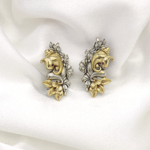 Oxidized dual-tone Ganesha cuff earrings with gold-toned and silver floral detailing by joyrias