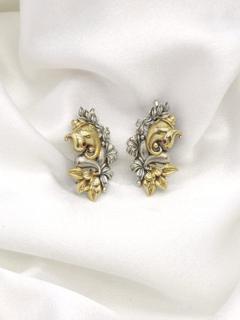 Oxidized dual-tone Ganesha cuff earrings with gold-toned and silver floral detailing by joyrias