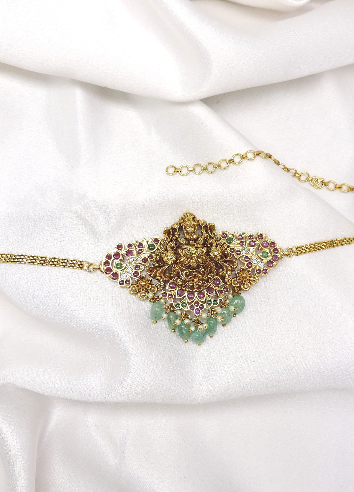 Exquisite temple gold-toned choker necklace with Lakshmi centerpiece, colorful stones and green bead drops by joyrias