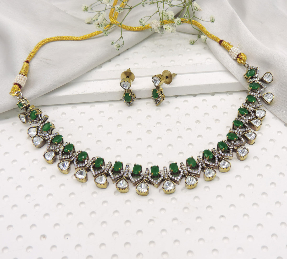 Emerald green kundan inspired necklace set with crystal drop detailing and matching earrings