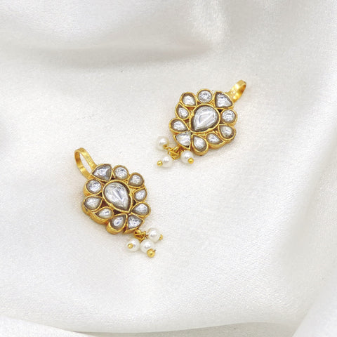 Gold-toned kundan pearl drop earrings with floral detailing by joyrias