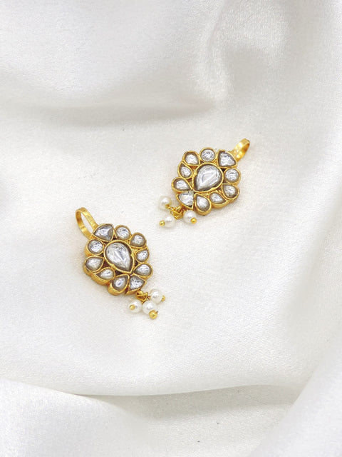 Gold-toned kundan pearl drop earrings with floral detailing by joyrias