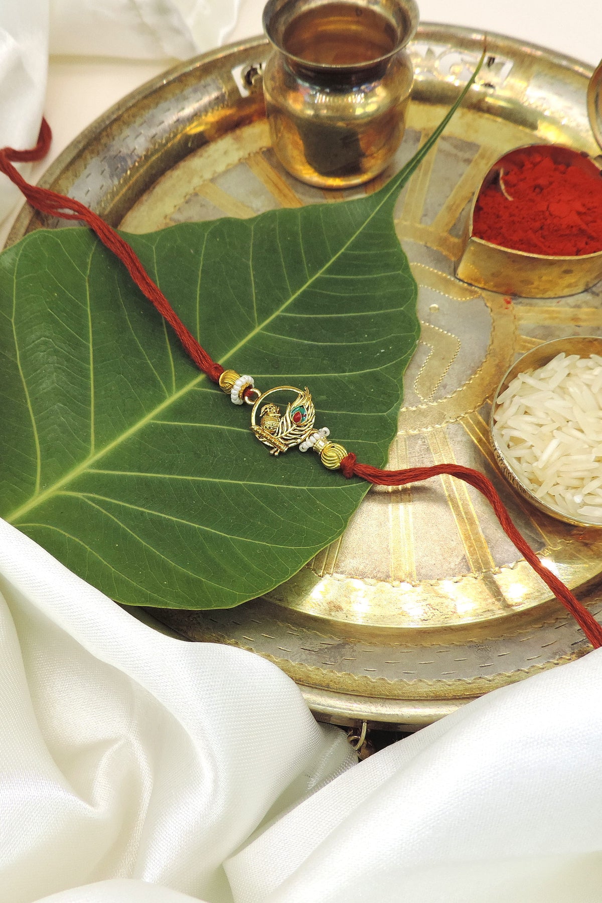 Elegant Peacock Rakhi with Pearl Accents | Handmade Raksha Bandhan Thread
