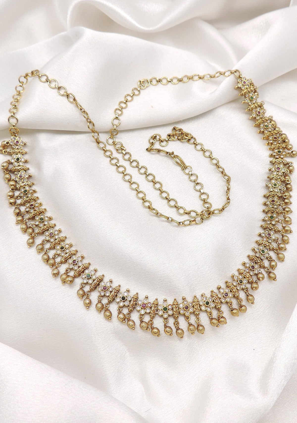 Antique kundan AD gold-toned waist chain with intricate detailing and hanging accents by joyrias