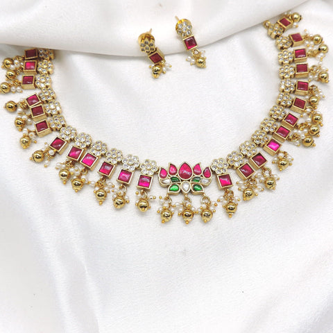 Traditional square-cut kundan temple choker necklace set with pink and green stones and matching earrings by joyrias