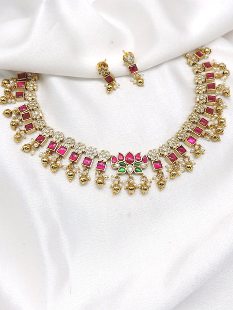 Traditional square-cut kundan temple choker necklace set with pink and green stones and matching earrings by joyrias