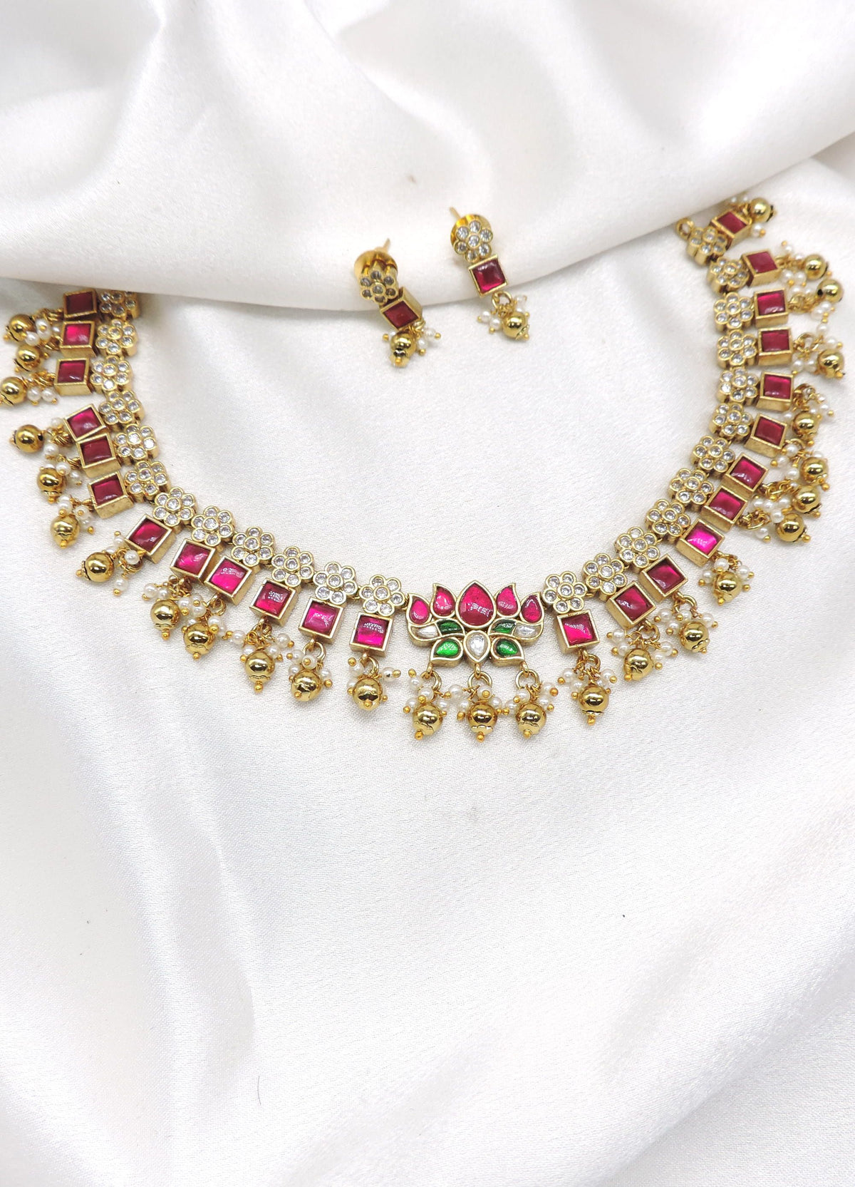 Traditional square-cut kundan temple choker necklace set with pink and green stones and matching earrings by joyrias