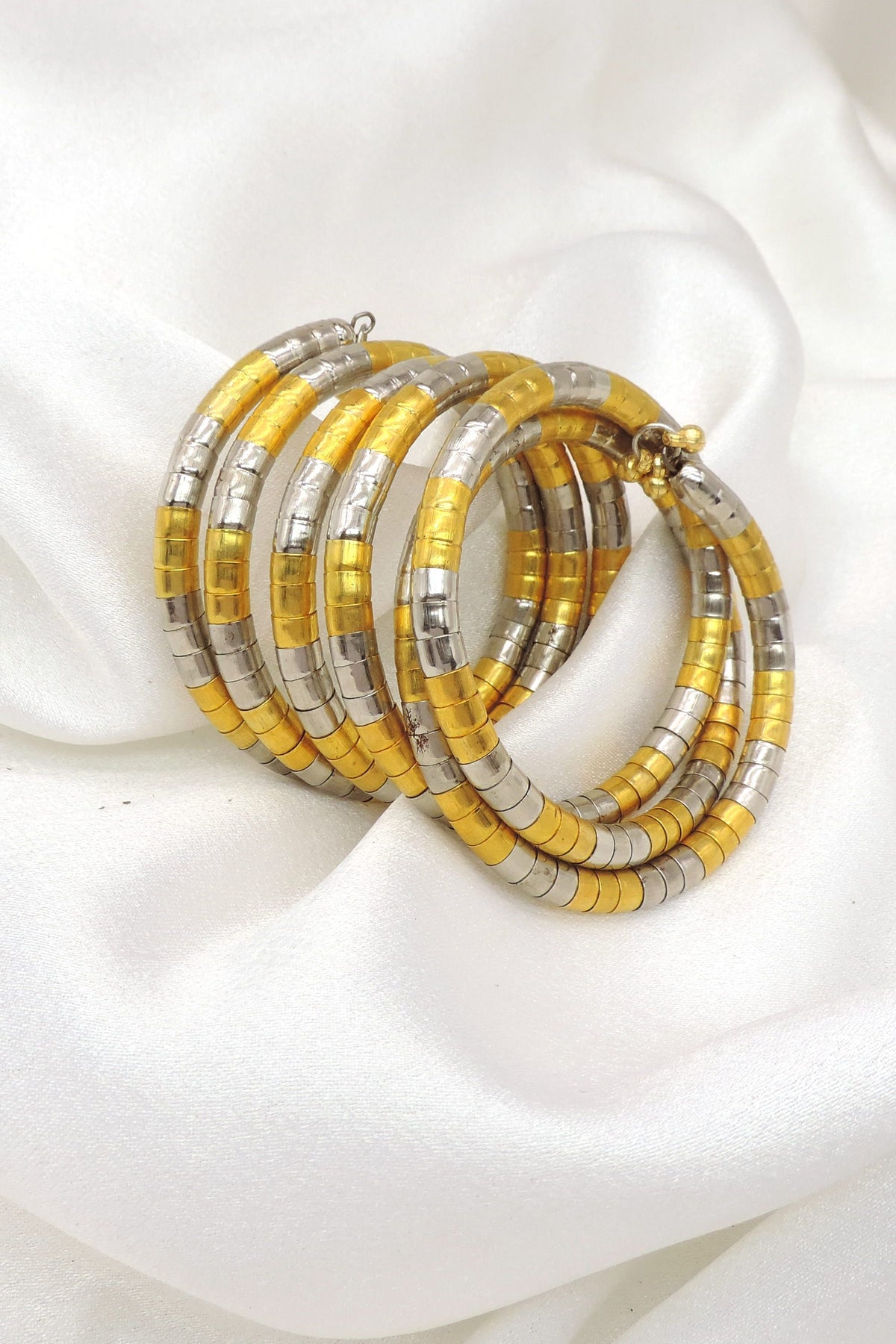 Dual-tone gold silver spiral hoop cuff bracelet with layered traditional detailing by joyrias
