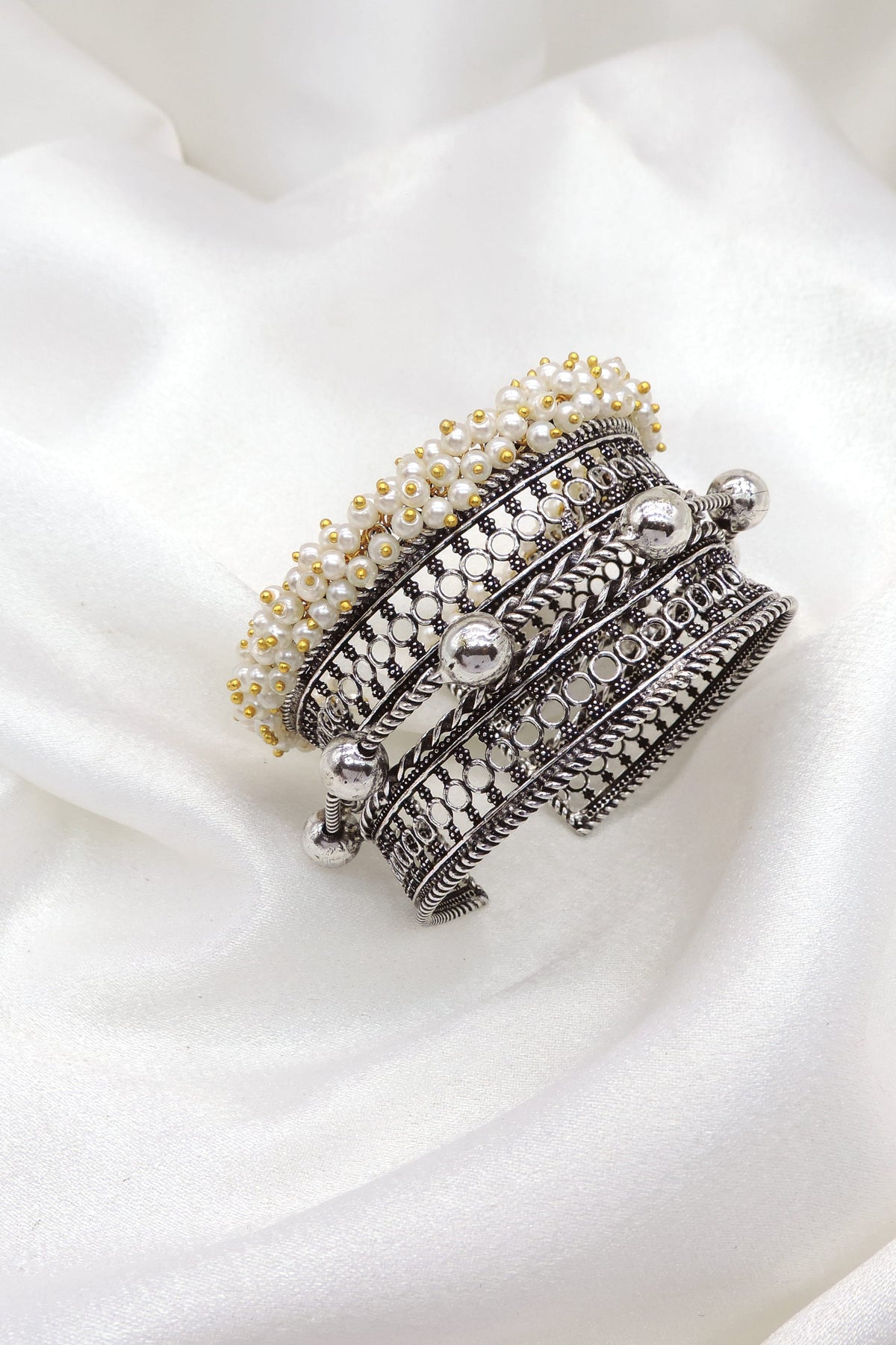 Oxidized silver layered pearl cuff bracelet with intricate textured detailing by joyrias