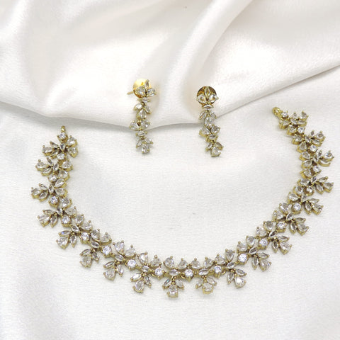 Gold-toned floral AD necklace set with sparkling stones and matching earrings by joyrias