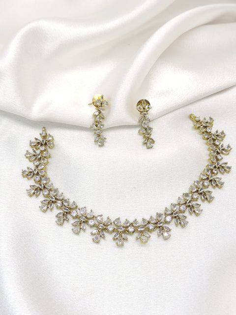 Gold-toned floral AD necklace set with sparkling stones and matching earrings by joyrias