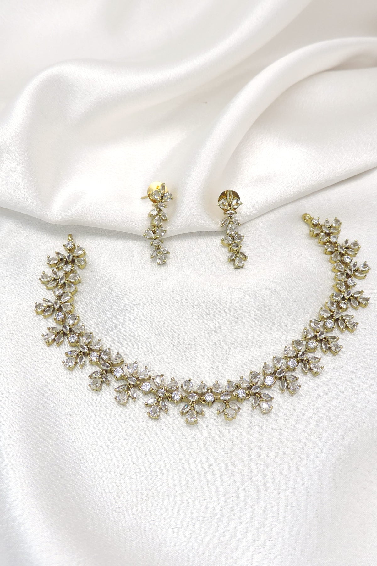 Gold-toned floral AD necklace set with sparkling stones and matching earrings by joyrias