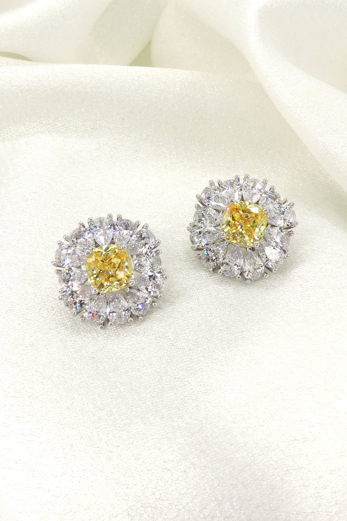 Canary yellow cushion AD CZ halo stud earrings by Joyrias