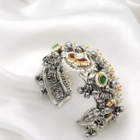 Oxidized silver multicolor temple cuff bracelet with red green stones, pearl detailing, and dangling silver charms by joyrias