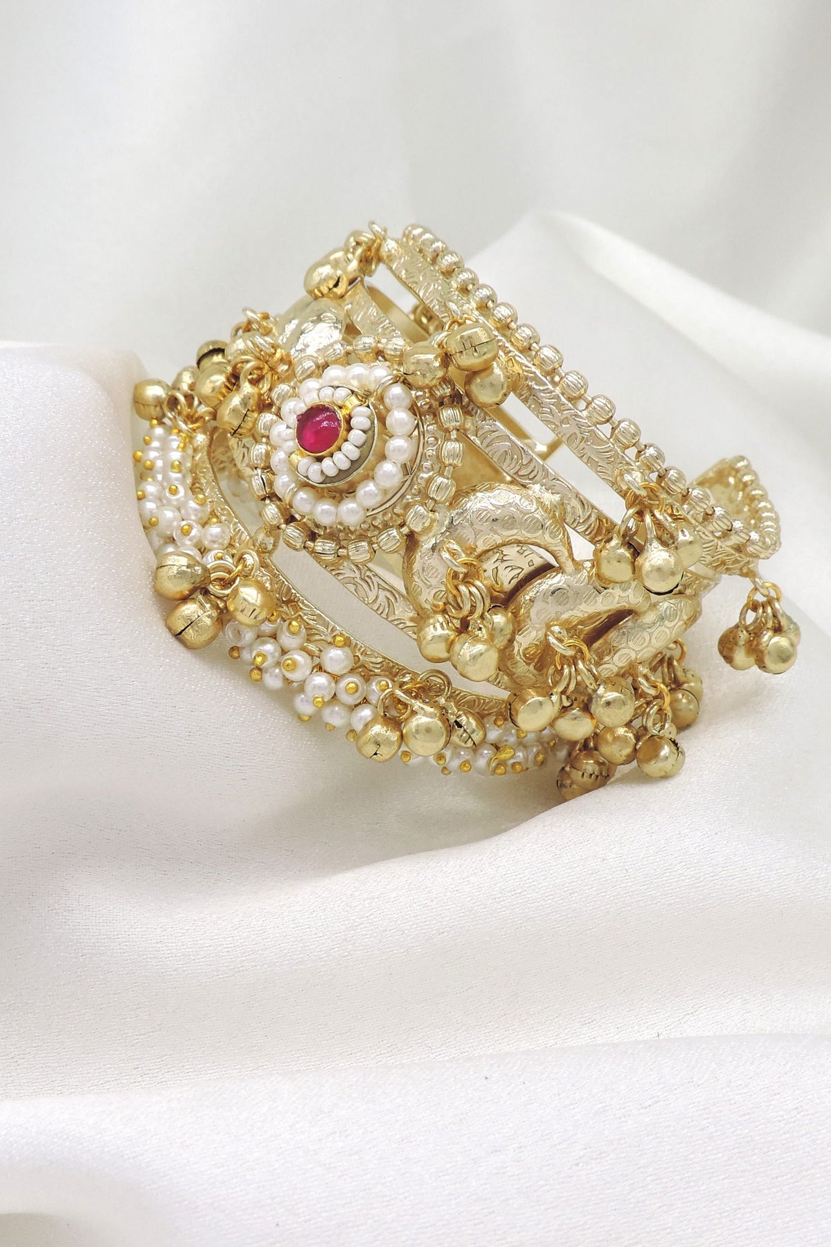 Gold-toned traditional temple elephant cuff bracelet with red stone and pearl detailing by joyrias