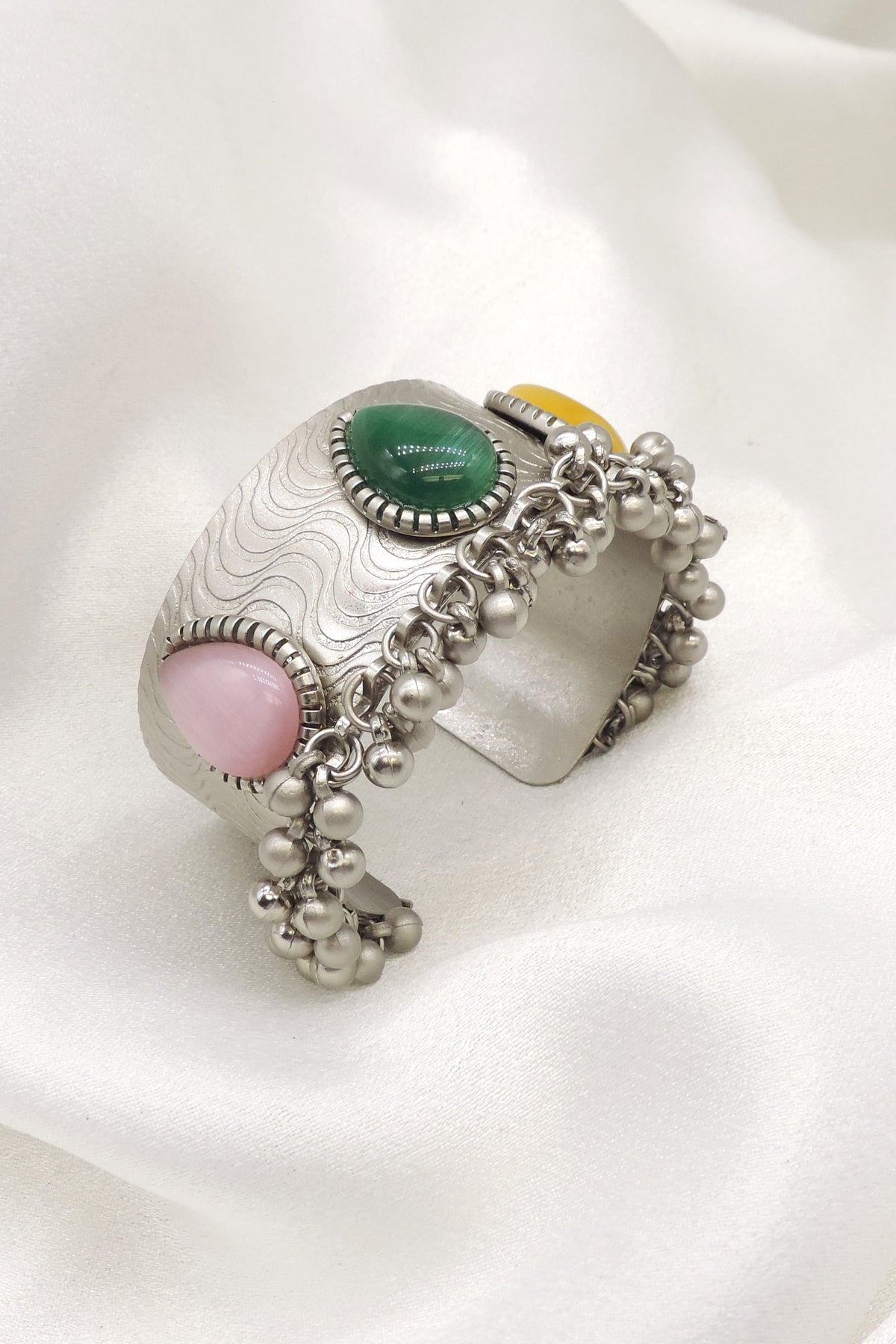 Oxidized silver multicolor stone cuff bracelet with green pink stones and delicate bead detailing by joyrias
