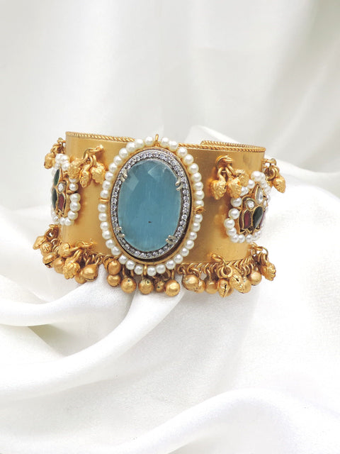 Gold-toned blue stone pearl cuff bracelet with colorful side detailing and dangling charms by joyrias