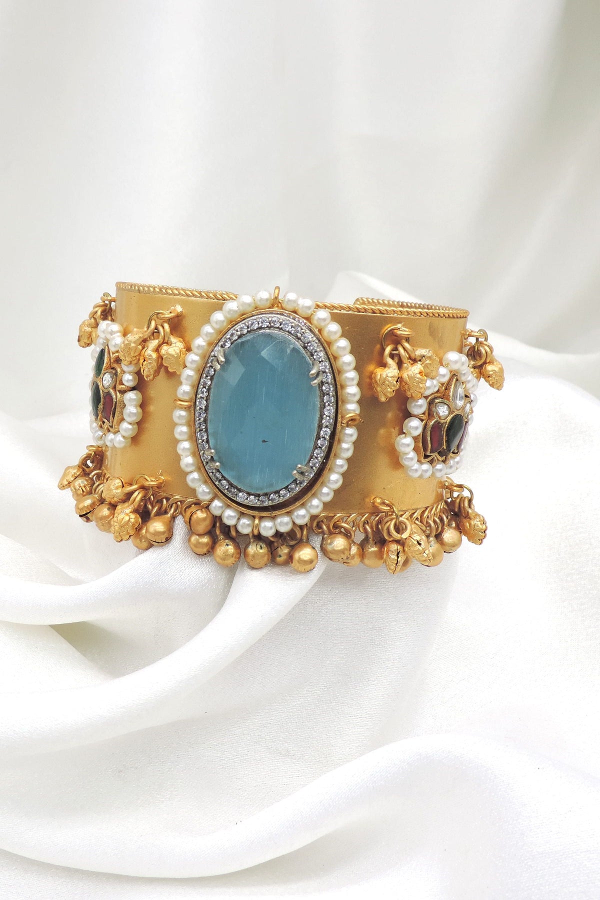 Gold-toned blue stone pearl cuff bracelet with colorful side detailing and dangling charms by joyrias