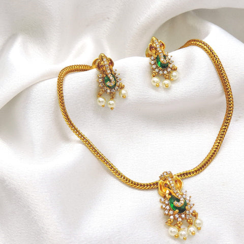 Regal gold-toned temple green stone pearl necklace set with matching earrings by joyrias
