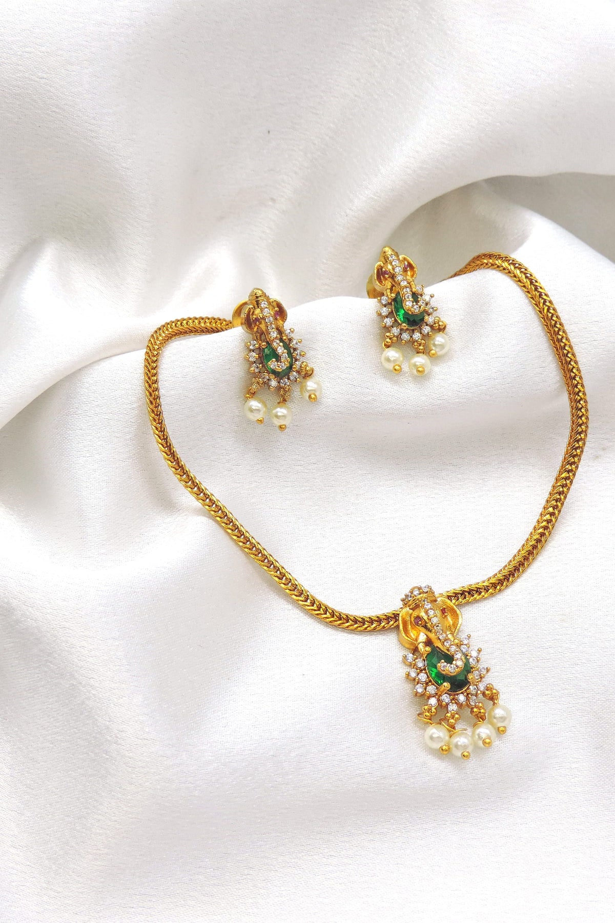 Regal gold-toned temple green stone pearl necklace set with matching earrings by joyrias