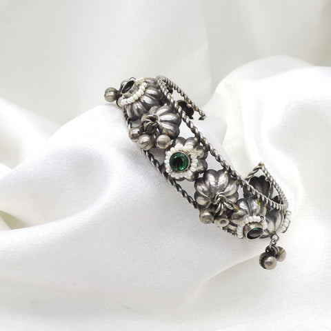 Oxidized silver green stone floral cuff bracelet with pearl detailing and dangling silver charms by joyrias