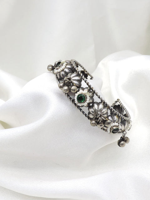 Oxidized silver green stone floral cuff bracelet with pearl detailing and dangling silver charms by joyrias