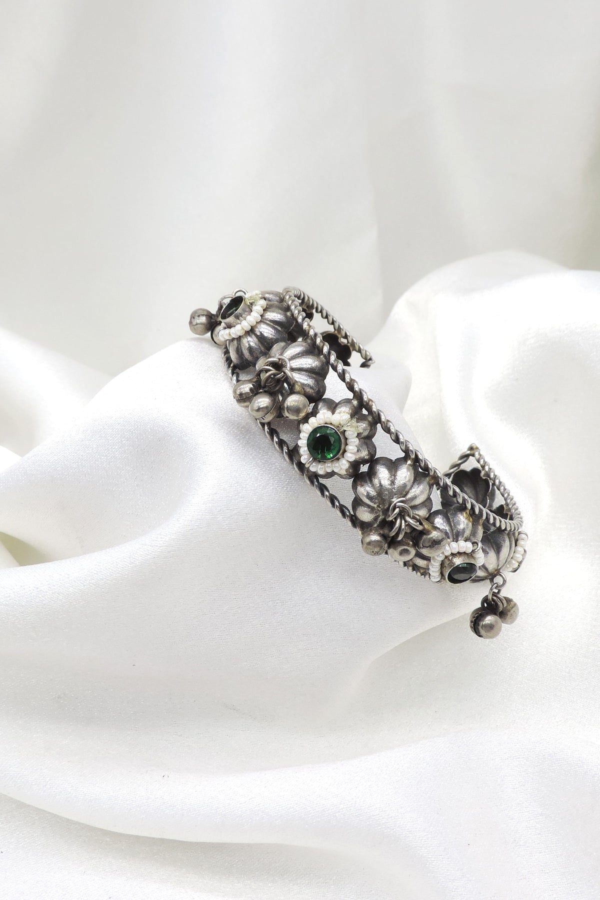 Oxidized silver green stone floral cuff bracelet with pearl detailing and dangling silver charms by joyrias