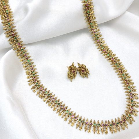 Classic long heritage temple necklace set with ruby and green stone detailing and matching earrings by joyrias
