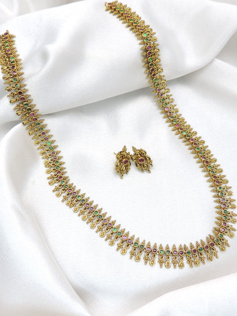 Classic long heritage temple necklace set with ruby and green stone detailing and matching earrings by joyrias