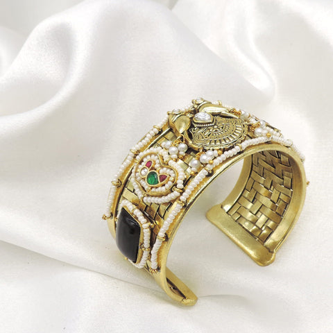Gold-toned black stone pearl temple cuff bracelet with intricate floral detailing by joyrias