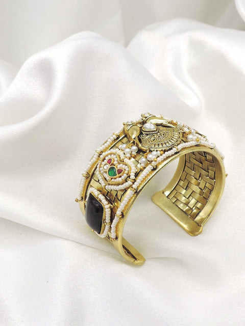 Gold-toned black stone pearl temple cuff bracelet with intricate floral detailing by joyrias