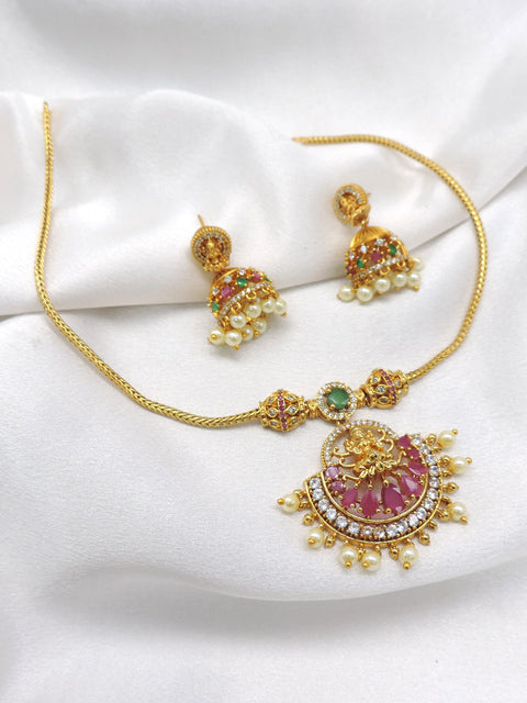 Antique ruby emerald temple necklace set with Lakshmi pendant, pearl detailing and matching jhumka earrings by joyrias