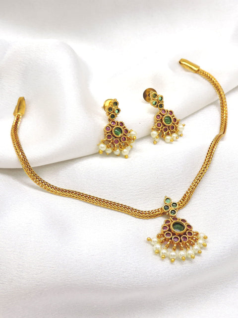 Royal gold-toned temple necklace set with green and ruby stones and pearl detailing by joyrias