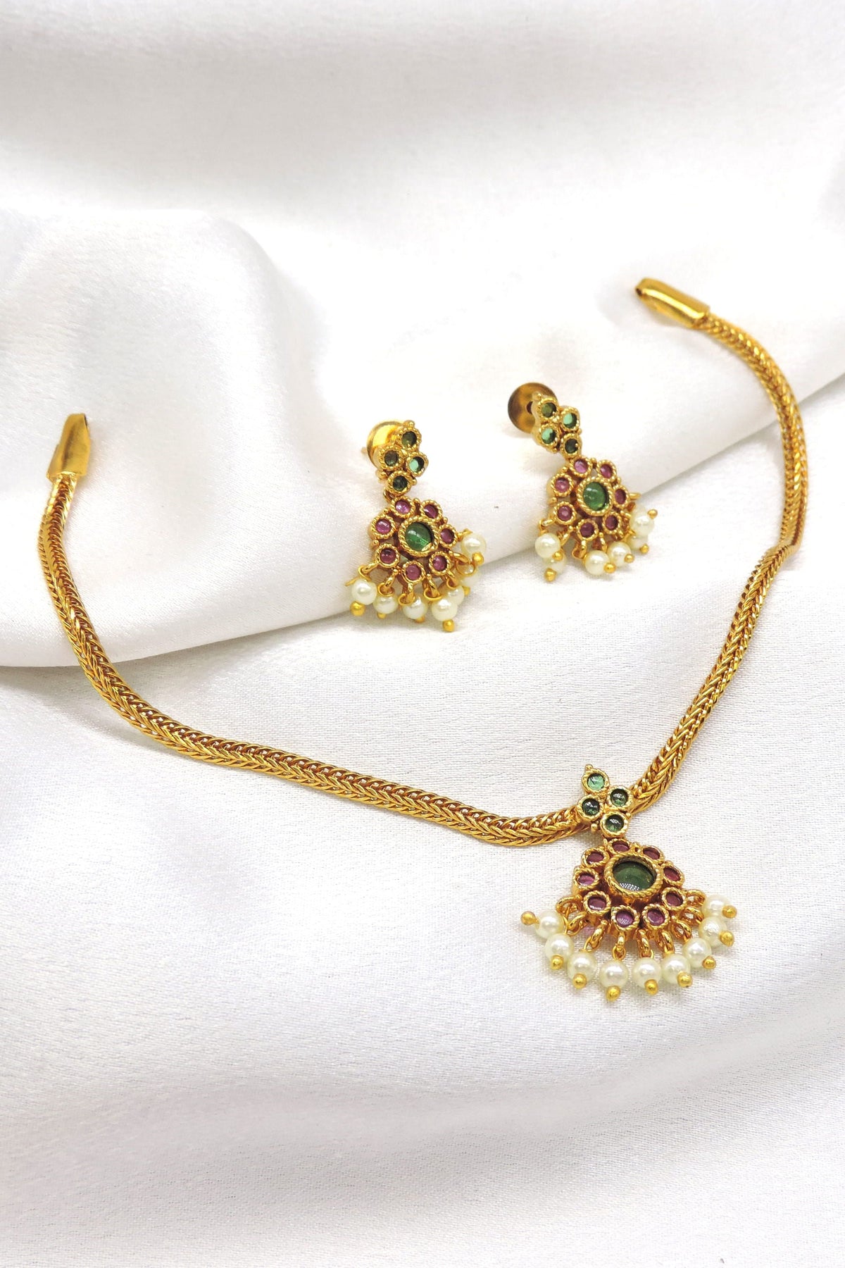 Royal gold-toned temple necklace set with green and ruby stones and pearl detailing by joyrias