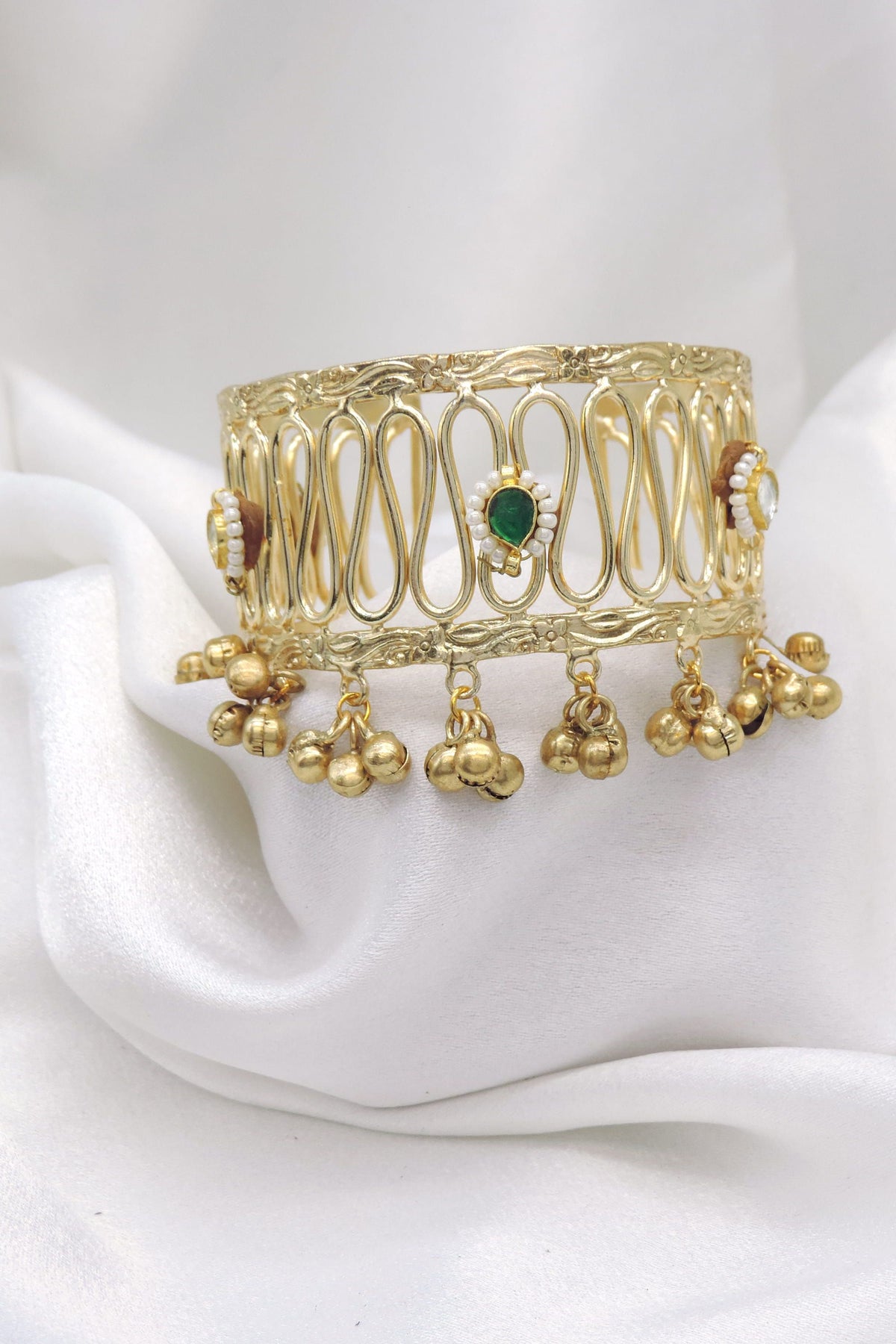 Gold-toned green stone ghungroo cuff bracelet with pearl detailing and dangling charms by joyrias
