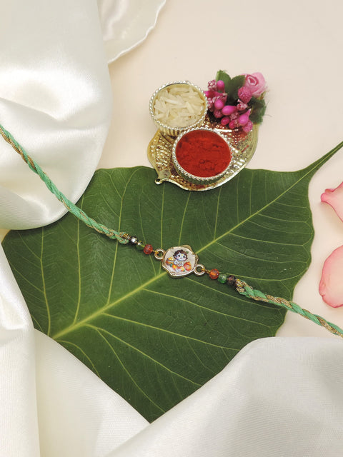 A traditional Indian Rakhi bracelet with a Krishna colorful charm