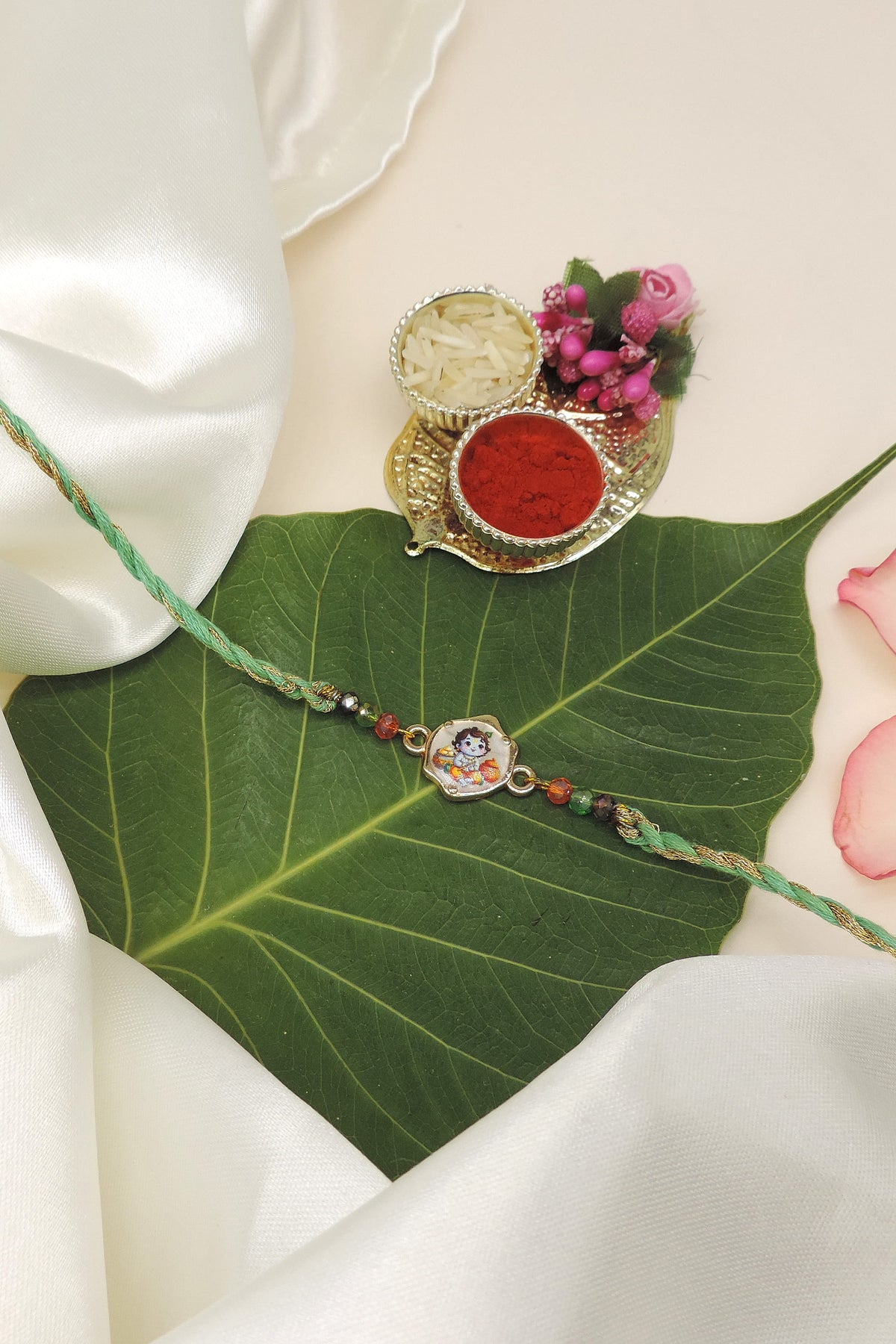 A traditional Indian Rakhi bracelet with a Krishna colorful charm
