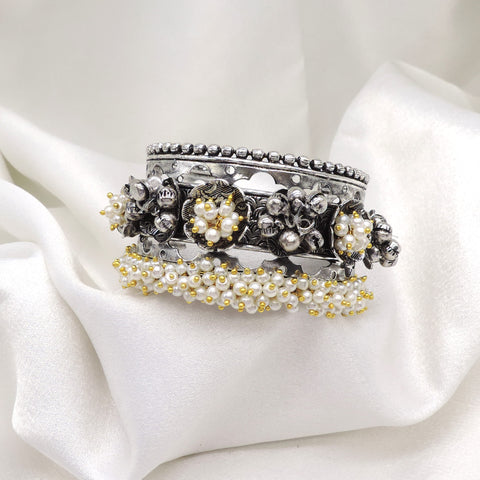 Oxidized silver pearl floral cuff bracelet with intricate detailing and gold-toned bead accents by joyrias