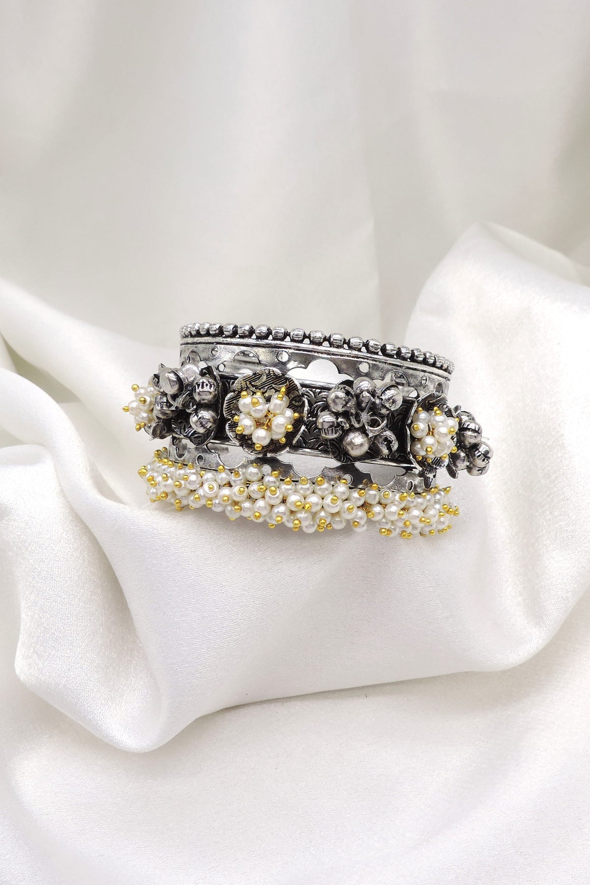 Oxidized silver pearl floral cuff bracelet with intricate detailing and gold-toned bead accents by joyrias