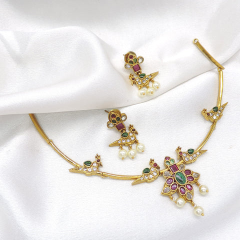 Inspire temple style gold-toned peacock choker necklace set with colorful stones, pearl detailing and matching earrings by joyrias