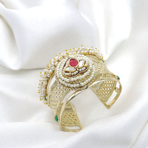 Gold-toned green maroon Kundan pearl cuff bracelet with floral detailing and intricate traditional accents by joyrias