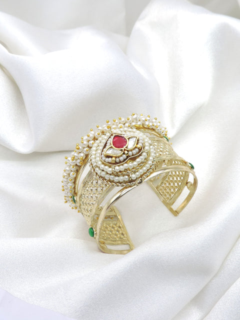 Gold-toned green maroon Kundan pearl cuff bracelet with floral detailing and intricate traditional accents by joyrias
