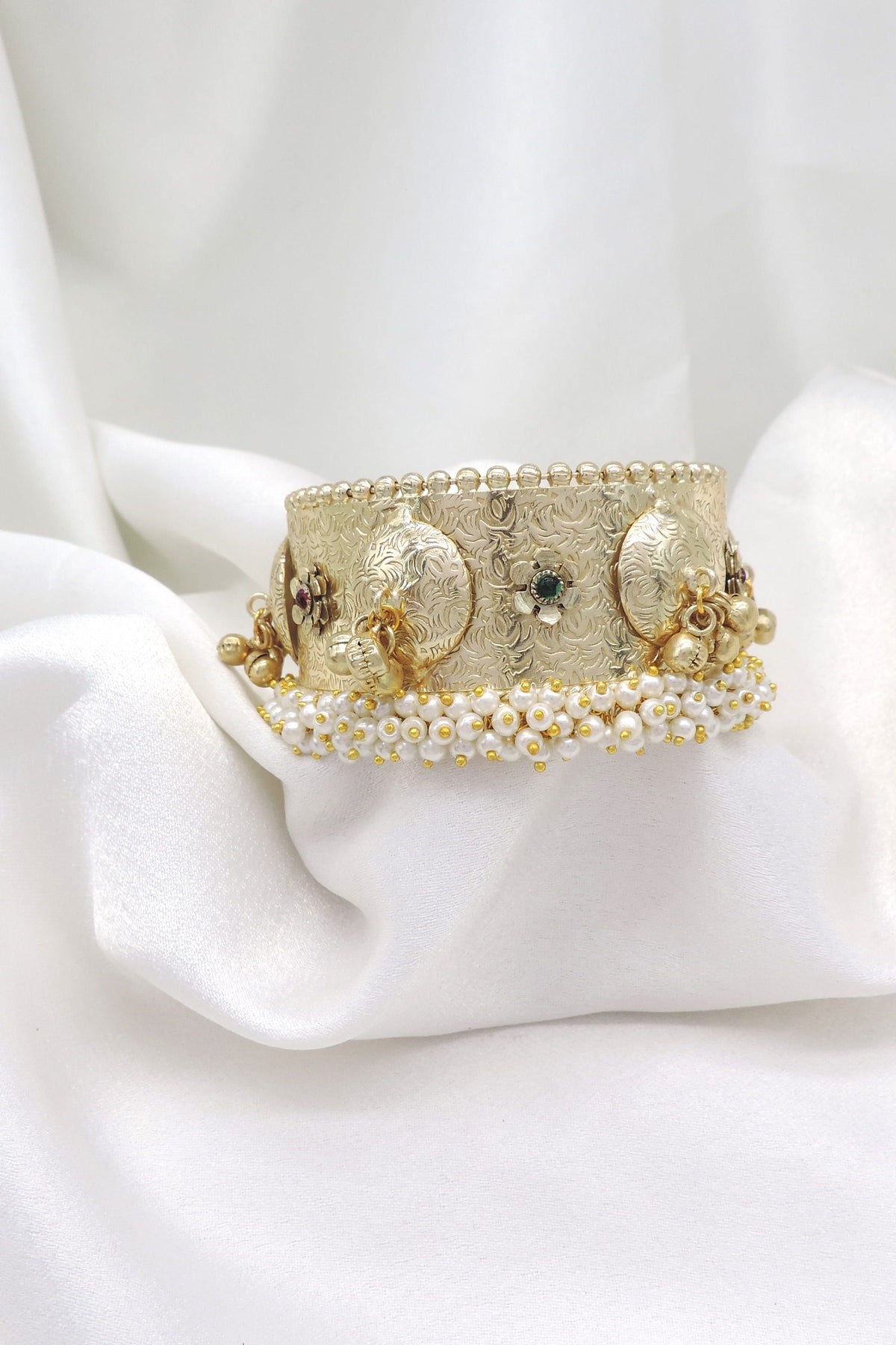 Gold-toned green pearl floral cuff bracelet with intricate engraved detailing and dangling charms by joyrias