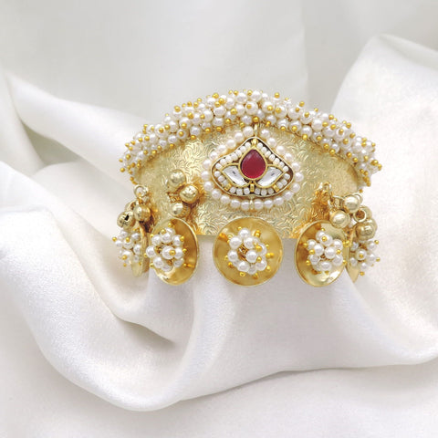 Gold-toned maroon pearl floral cuff bracelet with intricate traditional detailing and dangling charms by joyrias