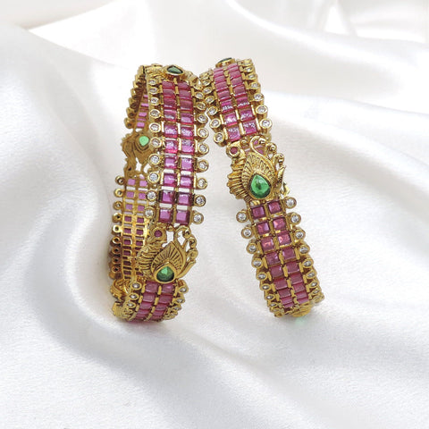 Royal emerald CZ AD bangle set with intricate gold-tone detailing by joyrias