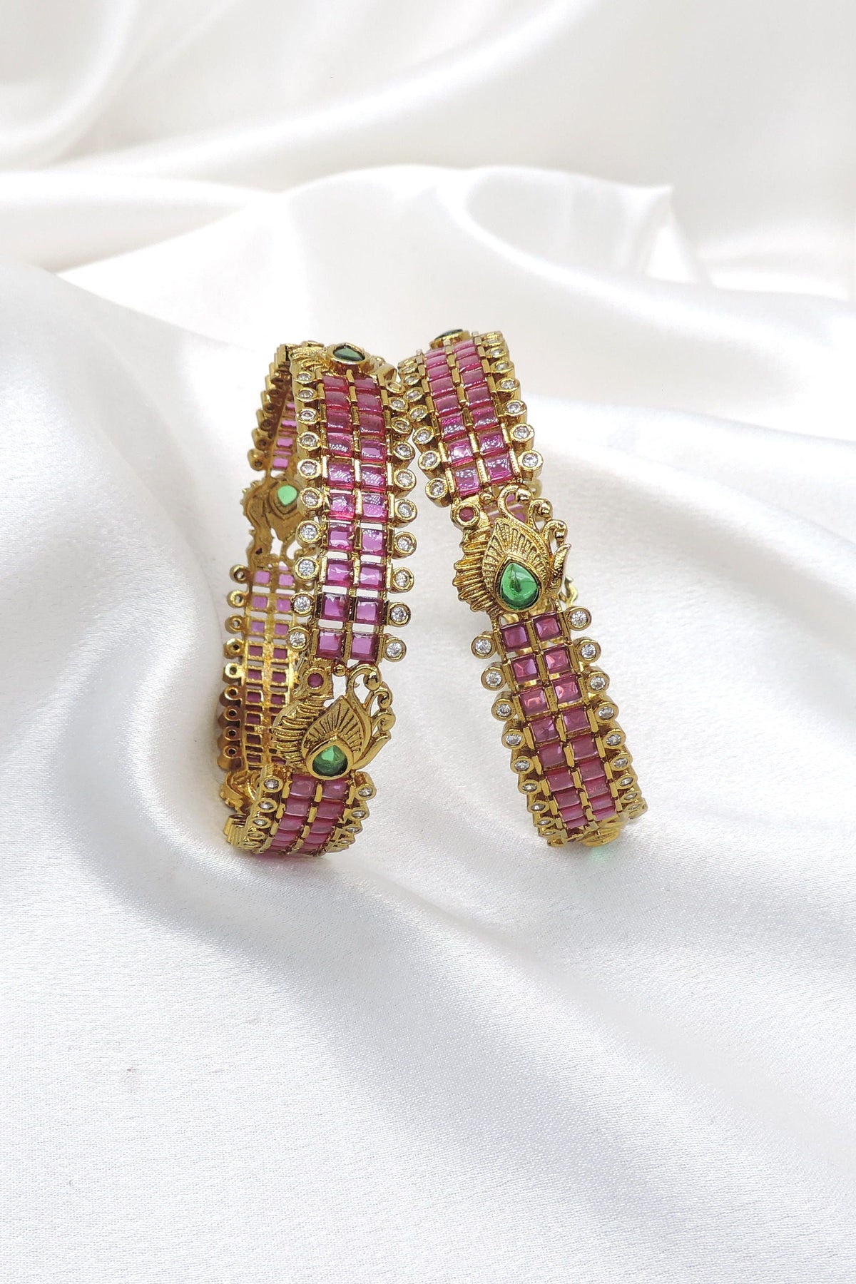 Royal emerald CZ AD bangle set with intricate gold-tone detailing by joyrias