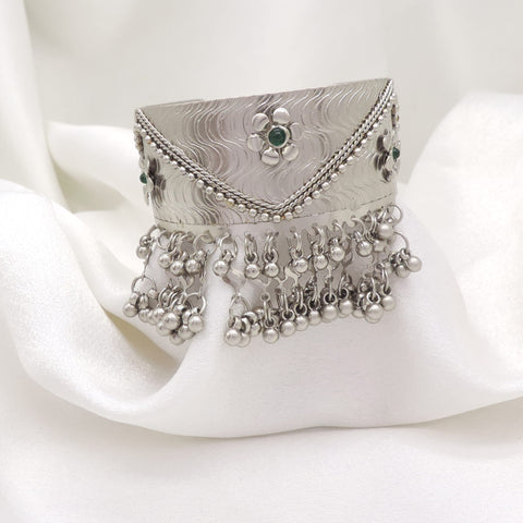 Oxidized silver green stone ghungroo cuff bracelet with engraved detailing and dangling silver charms by