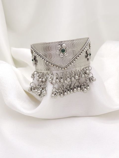 Oxidized silver green stone ghungroo cuff bracelet with engraved detailing and dangling silver charms by