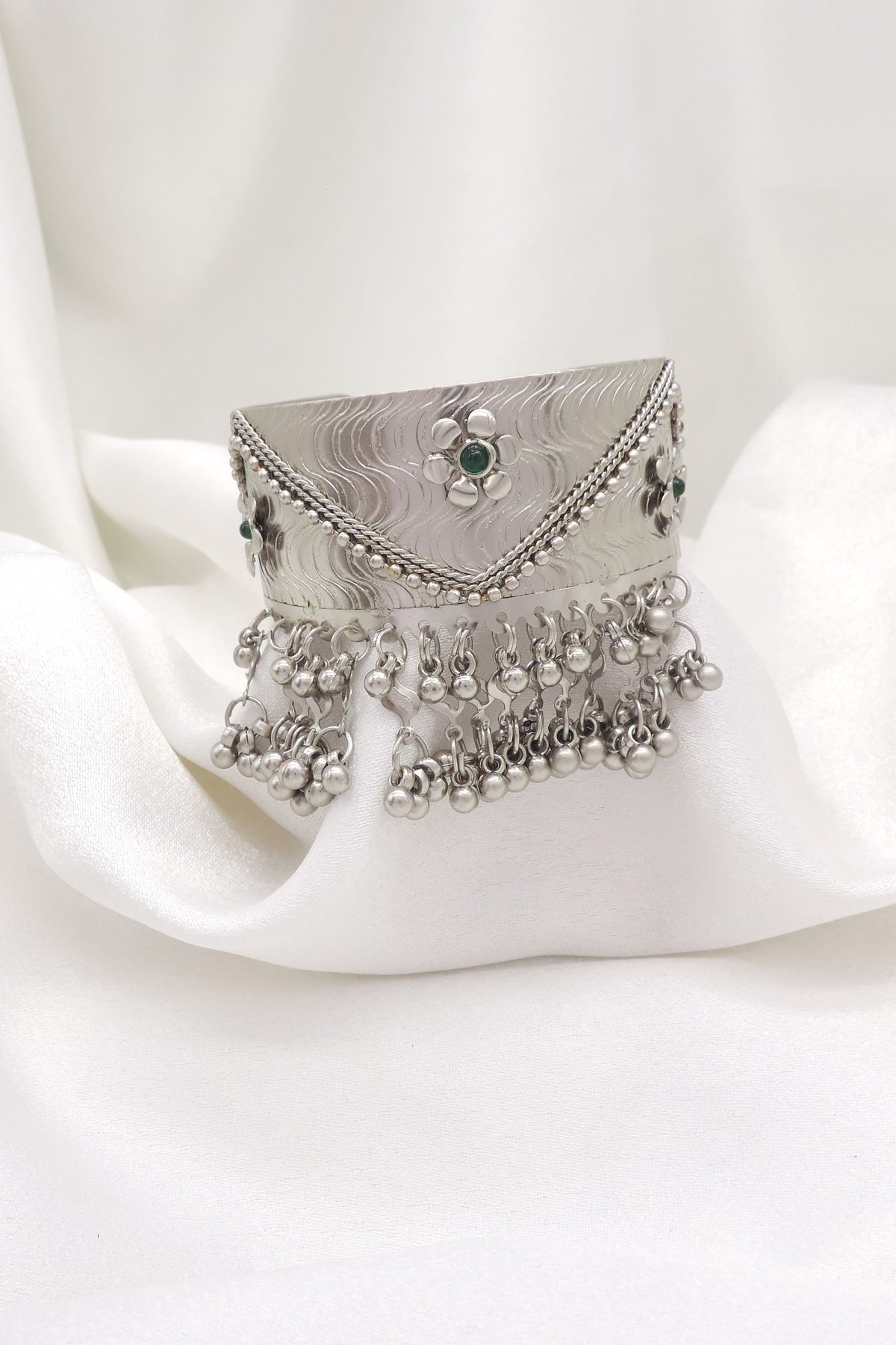 Oxidized silver green stone ghungroo cuff bracelet with engraved detailing and dangling silver charms by
