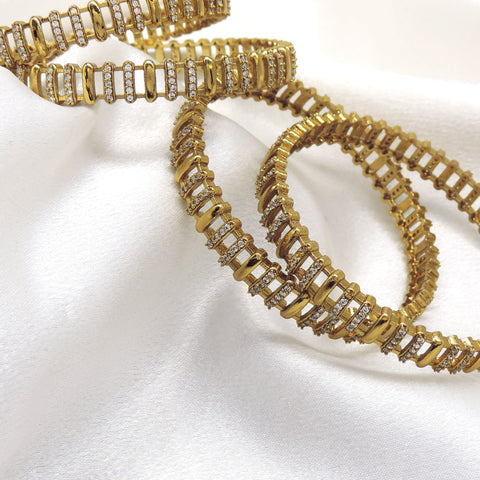 Gold plated CZ AD bangle set with intricate linked detailing by joyrias